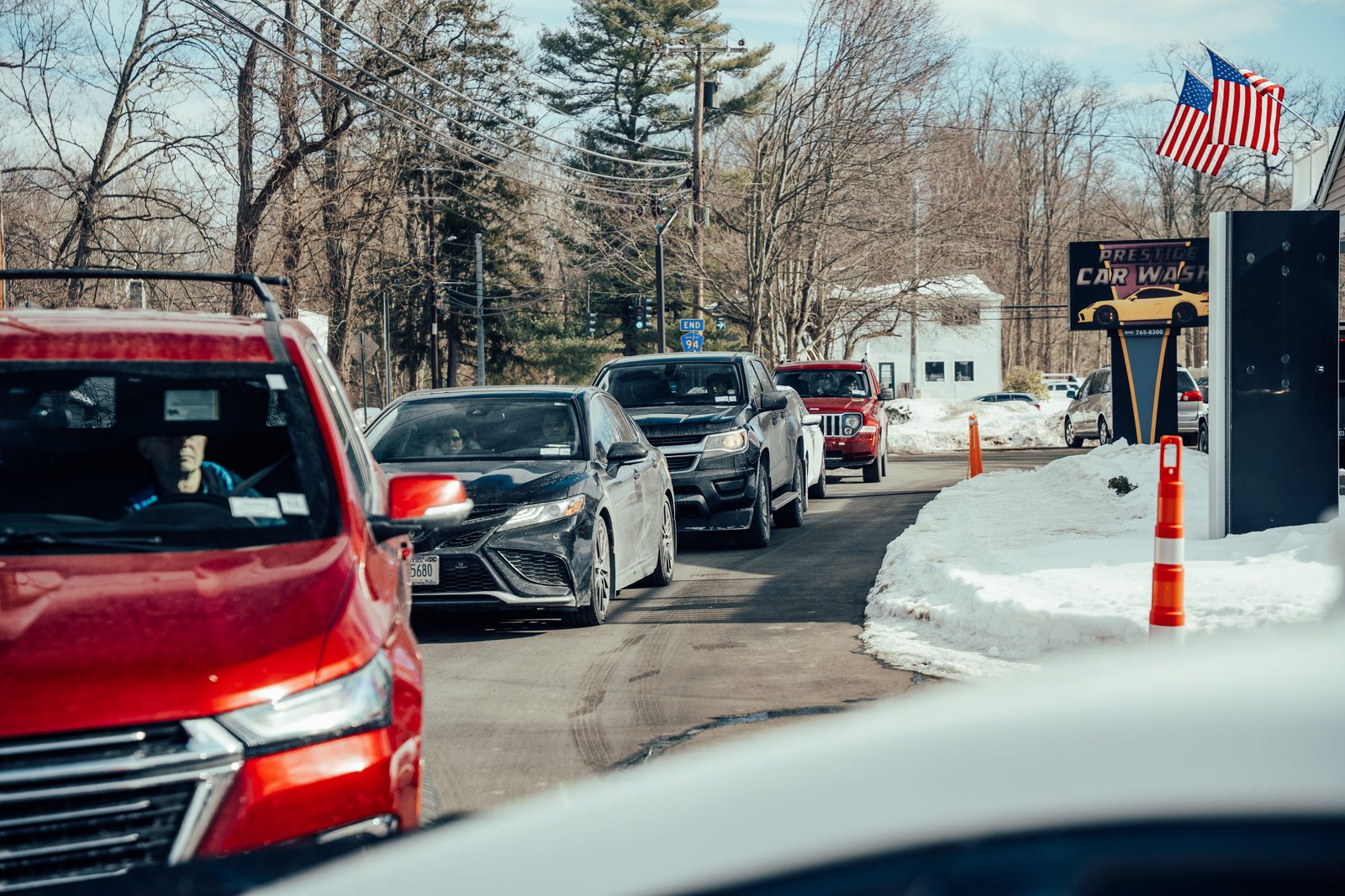 A line of cars waiting at Prestige Car Wash in Hopewell Junction NY on a busy day