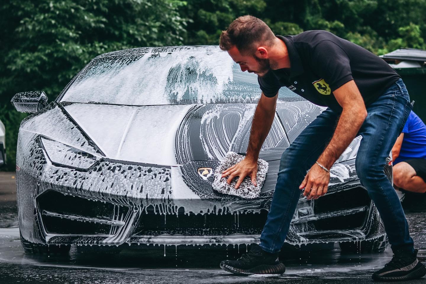 Prestige team member hand washing a Lamborghini Huracán with a microfiber mitt at the Hopewell Junction location