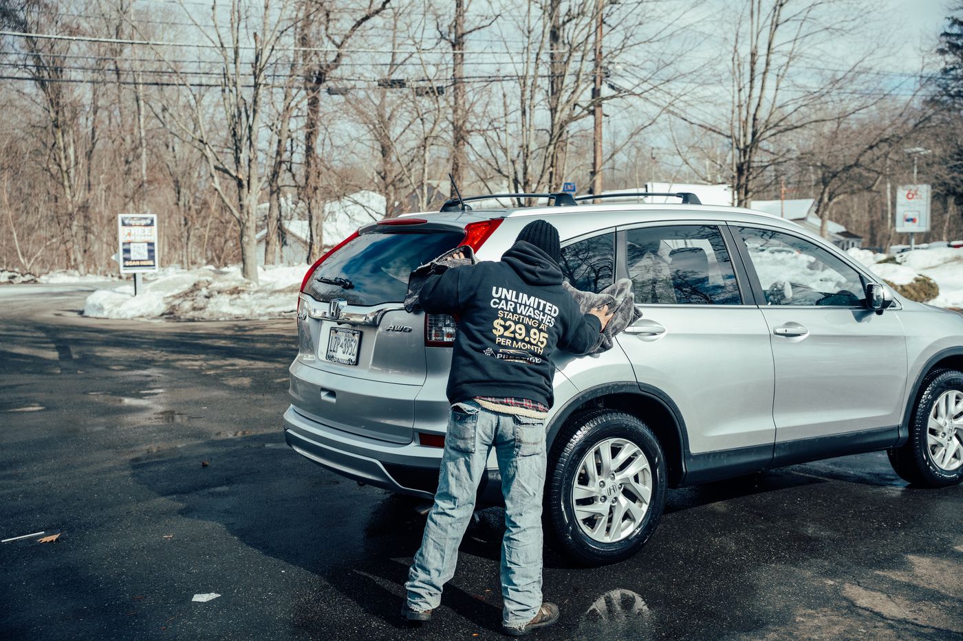 Prestige team hand-drying a car with a towel